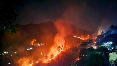 Flames rise during a forest fire near Saterakhal village in Rudraprayag district on Wednesday. (PTI) Flames rise during a forest fire near Saterakhal village in Rudraprayag district on Wednesday. (PTI)