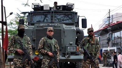 Security personnel stand guard in front of their armoured vehicle in Imphal, Manipur. (Reuters)