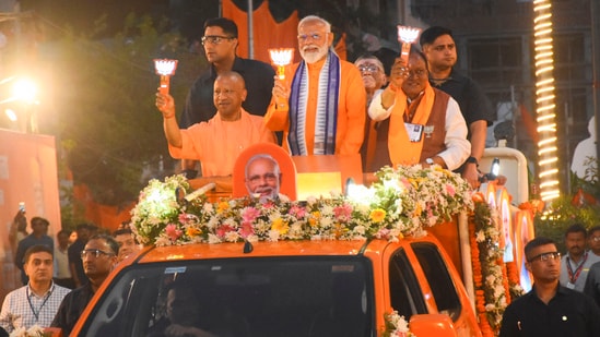 Prime Minister Narendra Modi with Uttar Pradesh chief minister Yogi Adityanath and others during an election campaign roadshow in Bareilly. (PTI)