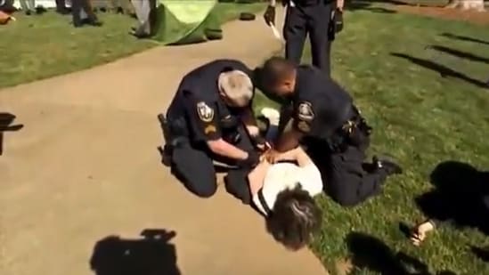 Two Georgia State police officers are trying to handcuff an Emory University professor.