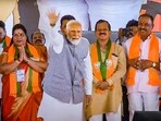 Prime Minister Narendra Modi waves at supporters during an election campaign rally for Lok Sabha polls in Uttara Kannada, Karnataka, on April 28,