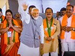 Prime Minister Narendra Modi waves at supporters during an election campaign rally for the Lok Sabha polls in Uttara Kannada, Karnataka, (PTI)