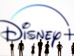 FILE PHOTO: Toy figures of people are seen in front of the displayed Disney + logo, in this illustration taken January 20, 2022. REUTERS/Dado Ruvic/Illustration/File Photo