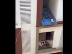 Toodler hangs from an apartment roof in Chennai
