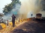 Nainital, Apr 27 (ANI): A firefighter attempts to control the fire caught in the forest in Nainital on Saturday. (ANI Photo)