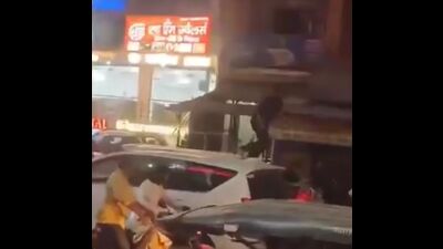 A screen grab from the viral video showing a man standing on the complainant’s car roof. A screen grab from the viral video showing a man standing on the complainant’s car roof.