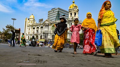 Pedestrians cross a road with its tarmac melting due to heat wave, in Esplanade area, in Kolkata, on Sunday. (PTI) Pedestrians cross a road with its tarmac melting due to heat wave, in Esplanade area, in Kolkata, on Sunday. (PTI)