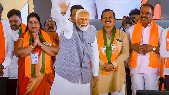 Prime Minister Narendra Modi waves at supporters during an election campaign rally for the Lok Sabha polls in Uttara Kannada, Karnataka, (PTI)