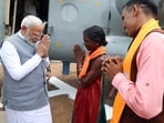 Prime Minister Narendra Modi being welcomed by Mohini Gowda, a fruit seller from Ankola ahead of his public rally for the Lok Sabha polls, at Sirsi in Uttara Kannada on Monday. (ANI Photo)(ANI)