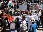 Pro-Israel counter-protesters display Israeli flags near protesters attending a demonstration in support of Palestinians in Gaza, amid the ongoing conflict between Israel and the Palestinian Islamist group Hamas, at the University of California Los Angeles (UCLA) in Los Angeles, California, U.S. April 28, 2024. REUTERS/David Swanson