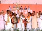 Union Home Minister Amit Shah being felicitated with 'Trishool' a trident during a public meeting ahead of the Lok Sabha polls, in Mainpuri on Sunday (Amit Shah X)