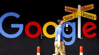 Google layoffs: A man walks past a logo of Alphabet Inc's Google in front of an office building in Zurich, Switzerland. (REUTERS)
