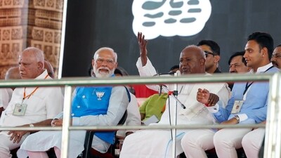 Prime Minister Narendra Modi attends a public meeting ahead of Lok Sabha polls in Mysuru on Sunday. Former Prime Minister H.D. Deve Gowda, BJP leader B S Yediyurappa and others also seen. (BJP  )