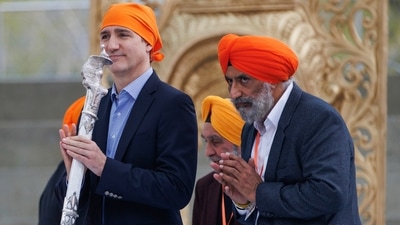 Canadian Prime Minister Justin Trudeau, left, reacts after receiving a ceremonial talwar as a special gift from the Ontario Sikhs and Gurudwara Council after speaking during Khalsa day celebrations at City Hall in Toronto, Sunday. (AP) Canadian Prime Minister Justin Trudeau, left, reacts after receiving a ceremonial talwar as a special gift from the Ontario Sikhs and Gurudwara Council after speaking during Khalsa day celebrations at City Hall in Toronto, Sunday. (AP)