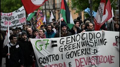People hold a banner reading “G7=genocide Greenwashing. Against governments of War and devastations" during a demonstration against the G7 Climate, Energy and Environment held in Turin, on Sunday. (AFP) People hold a banner reading “G7=genocide Greenwashing. Against governments of War and devastations" during a demonstration against the G7 Climate, Energy and Environment held in Turin, on Sunday. (AFP)