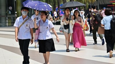 Pedestrians shield themselves from the sun with umbrellas to combat the heat outside Siam Paragon shopping mall in Bangkok . (AFP) Pedestrians shield themselves from the sun with umbrellas to combat the heat outside Siam Paragon shopping mall in Bangkok . (AFP)