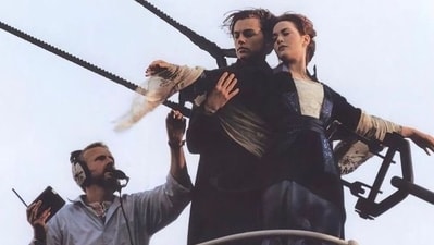James Cameron directs Leonardo DiCaprio and Kate Winslet on the sets of Titanic as they shoot the iconic arms-stretched-on-the-bow scene. James Cameron directs Leonardo DiCaprio and Kate Winslet on the sets of Titanic as they shoot the iconic arms-stretched-on-the-bow scene.