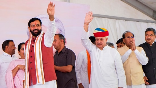 Haryana CM Nayab Singh Saini with BJP candidate Rao Inderjit Singh during the latter's nomination filing rally, in Gurugram, Haryana.(PTI)