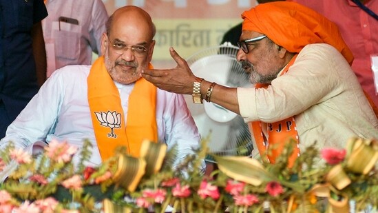 Home Minister and BJP leader Amit Shah with party candidate Giriraj Singh during a public meeting, in Begusarai, Bihar.(PTI)