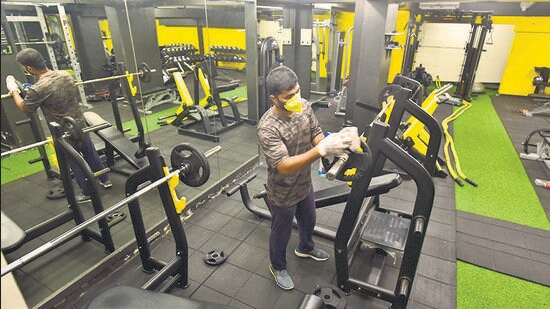 Mumbai, India - Oct. 19, 2020: Trainer Nikhil Ghodekar of Image Fitness, sanitize the Gym equipments which are to re-opened after Dussera in Maharashtra, at Grant Road in Mumbai, India, on Monday, October 19, 2020. (Photo by Anshuman Poyrekar/Hindustan Times) (Anshuman Poyrekar/HT Photo)