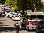 Multiple law enforcement vehicles respond in the neighborhood where several officers on a task force trying to serve a warrant were shot in Charlotte, N.C., Monday, April 29, 2024. (Melissa Melvin-Rodriguez/The Charlotte Observer via AP)