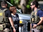 Members of FBI talk with each other at the scene of a shooting on Galway Drive in Charlotte, N.C., on Monday, April 29, 2024, Multiple law enforcement officers were shot while serving a warrant for a felon wanted for possessing a firearm. (Khadejeh Nikouyeh/The Charlotte Observer via AP) Members of FBI talk with each other at the scene of a shooting on Galway Drive in Charlotte, N.C., on Monday, April 29, 2024, Multiple law enforcement officers were shot while serving a warrant for a felon wanted for possessing a firearm. (Khadejeh Nikouyeh/The Charlotte Observer via AP)