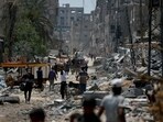 EDITORS NOTE: Graphic content / Palestinians walk amid the rubble of destroyed buildings in Nuseirat, in the central Gaza Strip on April 29, 2024, amid the ongoing conflict in the Palestinian territory between Israel and the militant group Hamas. (Photo by AFP)
