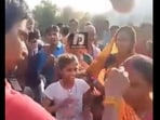 Bihar: Man applying sindoor to mother-in-law's hairline. Bihar: Man applying sindoor to mother-in-law's hairline.