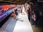 Constable Uma pulling out the passenger stuck between train and platform.  