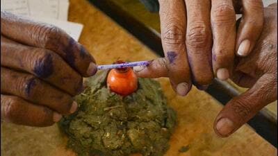 A woman gets her finger marked with indelible ink before casting her vote. (HT File Photo) A woman gets her finger marked with indelible ink before casting her vote. (HT File Photo)