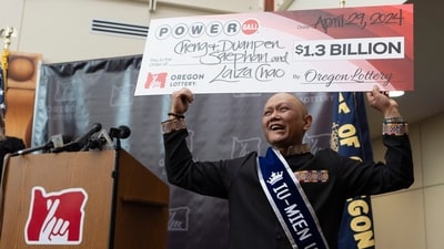 Cheng "Charlie" Saephan holds display check above his head after speaking during a news conference where it was revealed that he was one of the winners of the $1.3 billion Powerball jackpot at the Oregon Lottery headquarters on Monday, April 29, 2024, in Salem, Ore. (AP Photo/Jenny Kane) (AP) Cheng "Charlie" Saephan holds display check above his head after speaking during a news conference where it was revealed that he was one of the winners of the $1.3 billion Powerball jackpot at the Oregon Lottery headquarters on Monday, April 29, 2024, in Salem, Ore. (AP Photo/Jenny Kane) (AP)
