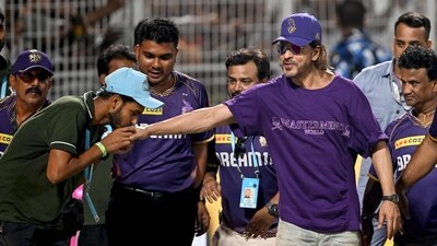 A groundman kisses the hands of Shah Rukh Khan after their win. Shah Rukh has been attending quiet a few matches to support his team at the IPL. (Photo by DIBYANGSHU SARKAR / AFP) / -- IMAGE RESTRICTED TO EDITORIAL USE - STRICTLY NO COMMERCIAL USE -- (AFP) A groundman kisses the hands of Shah Rukh Khan after their win. Shah Rukh has been attending quiet a few matches to support his team at the IPL. (Photo by DIBYANGSHU SARKAR / AFP) / -- IMAGE RESTRICTED TO EDITORIAL USE - STRICTLY NO COMMERCIAL USE -- (AFP)