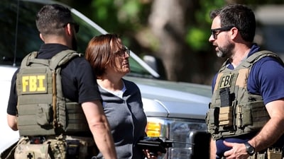 Members of FBI talk with each other at the scene of a shooting on Galway Drive in Charlotte, N.C., on Monday, April 29, 2024, Multiple law enforcement officers were shot while serving a warrant for a felon wanted for possessing a firearm. (Khadejeh Nikouyeh/The Charlotte Observer via AP) (AP)