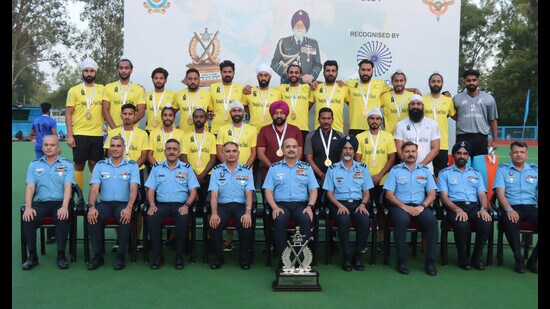 Air Chief Marshal Vivek R Chaudhari with Punjab and Sind Bank team that won the 5th edition of Marshal of the Air Force Arjan Singh Memorial Hockey tournament played at 3BRD, Air Force Station, in Chandigarh. (Keshav Singh/HT)