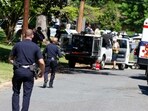 Charlotte Mecklenburg Police Department officers walk in the neighborhood where an officer-involved shooting took place in Charlotte, N.C., Monday, April 29, 2024 (AP Photo/Nell Redmond)