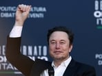 Elon Musk gestures as he attends a political festival in Italy.  