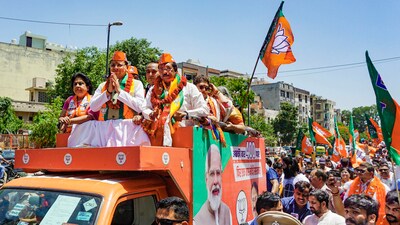 BJP candidate from East Delhi constituency Harsh Malhotra with Uttarakhand CM Pushkar Singh Dhami during a roadshow before Malhotra’s nomination filing in New Delhi. (PTI) BJP candidate from East Delhi constituency Harsh Malhotra with Uttarakhand CM Pushkar Singh Dhami during a roadshow before Malhotra’s nomination filing in New Delhi. (PTI)