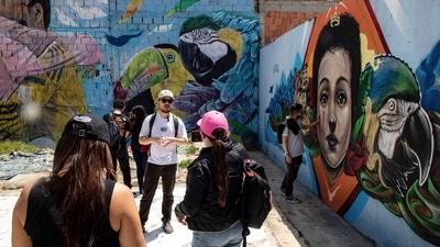 Every Sunday, the "TransMiCable cabins run through Ciudad Bolivar, one of Bogo's poorest neighbourhoods in the south of the Colombian capital, where daring tourists ride their cabins instead of the workers who use them every day. (Photo by Alejandro MARTINEZ / AFP) Every Sunday, the "TransMiCable cabins run through Ciudad Bolivar, one of Bogo's poorest neighbourhoods in the south of the Colombian capital, where daring tourists ride their cabins instead of the workers who use them every day. (Photo by Alejandro MARTINEZ / AFP)