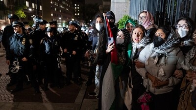 People hold their ground near a main gate at Columbia University in New York, Tuesday, April 30, 2024, as New York City police officers move to clear the area after a building was taken over by protesters earlier today. (AP Photo/Craig Ruttle) (AP) People hold their ground near a main gate at Columbia University in New York, Tuesday, April 30, 2024, as New York City police officers move to clear the area after a building was taken over by protesters earlier today. (AP Photo/Craig Ruttle) (AP)