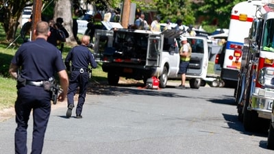 Charlotte Mecklenburg Police Department officers walk in the neighborhood where an officer-involved shooting took place in Charlotte, N.C., Monday, April 29, 2024 (AP Photo/Nell Redmond) (AP) Charlotte Mecklenburg Police Department officers walk in the neighborhood where an officer-involved shooting took place in Charlotte, N.C., Monday, April 29, 2024 (AP Photo/Nell Redmond) (AP)