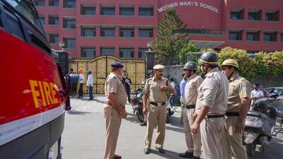 Police and fire department personnel outside Mother Mary’s School at Mayur Vihar. (PTI photo)