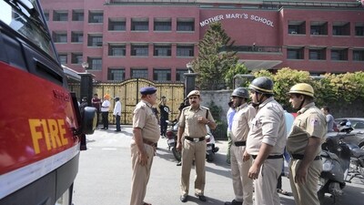 Police and fire department personnel outside Mother Mary's School at Mayur Vihar after multiple schools received a bomb threat in Delhi-NCR (PTI) Police and fire department personnel outside Mother Mary's School at Mayur Vihar after multiple schools received a bomb threat in Delhi-NCR (PTI)