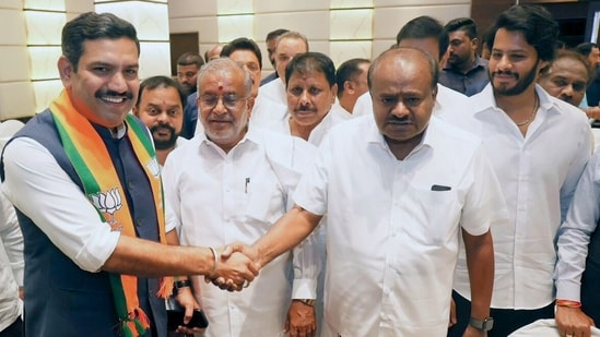 Karnataka Bharatiya Janata Party (BJP) president Vijayendra Yediyurappa (left) greets former state CM and Janata Dal (Secular) leader HD Kumaraswamy. (File photo)