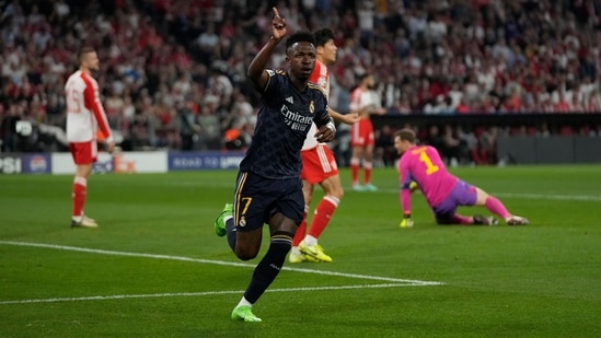 Real Madrid's Vinicius Junior celebrates after scoring his side's opening goal during the Champions League semifinal first leg soccer match between Bayern Munich and Real Madrid at the Allianz Arena in Munich (AP)