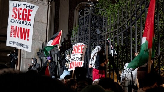 Pro-Palestianian protesters gather near a main gate at Columbia University in New York, Tuesday, April 30, 2024, just before New York City police officers cleared the area after a building was taken over by protesters earlier in the day. The building and a tent encampment were cleared during the operation. (AP Photo/Craig Ruttle)(AP)