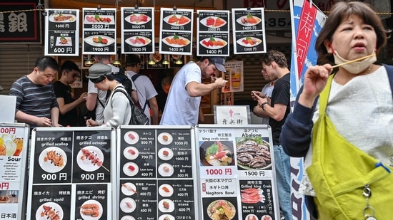 While the Japan is seeing record numbers of foreign visitors, the weakness of the yen, which fell to a new 34-year low against the US dollar on April 29, is boosting consumption, delighting certain traders. (Photo by Richard A. Brooks / AFP)