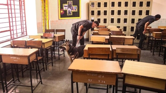 Noida: Security personnel inspect a class room at the DPS School after a bomb threat was received by the school via e-mail, at Sector 30, in Noida, Wednesday, May 1, 2024. (PTI Photo) (PTI05_01_2024_000037B) (PTI)