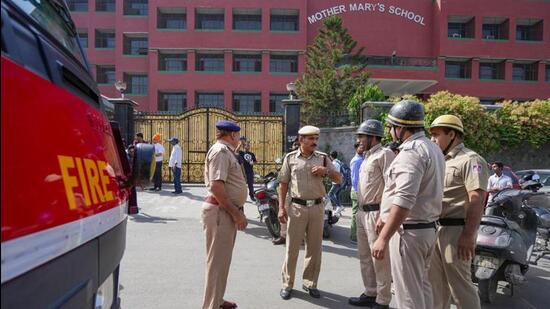 Police and fire department personnel outside Mother Mary’s School at Mayur Vihar. (PTI photo)
