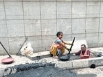 A worker inside a drain in Tilak Nagar, Chembur, wearing only an orange safety vest A worker inside a drain in Tilak Nagar, Chembur, wearing only an orange safety vest