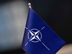 A flag with the logo of the North Atlantic Treaty Organization (NATO) A flag with the logo of the North Atlantic Treaty Organization (NATO)